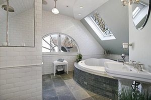 Bathroom with a blend of gray, white and black tile and solid wall color that matches one of the colors