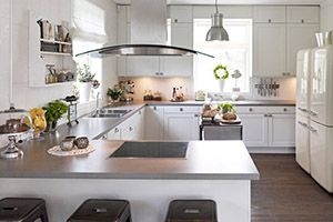 Kitchen with gray counters and white cabinets