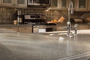 close of countertop made of granite, solid surface or quartz