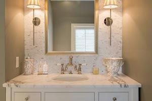 beautiful powder room with marble countertops