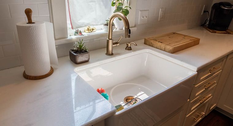 hand wiping a counter with an integrated sink