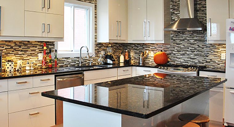 very sunny kitchen with granite countertops
