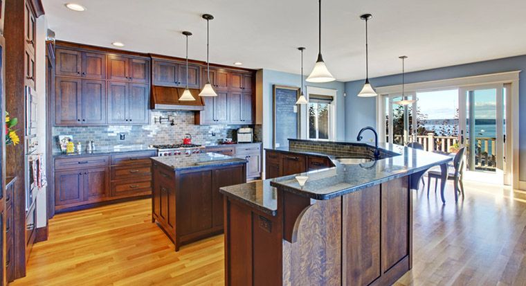 dual level kitchen island with a distinctive stone countertop