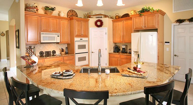 people in kitchen with granite countertops