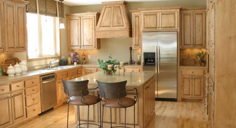 wood finish refrigerator blending in with wood cabinets