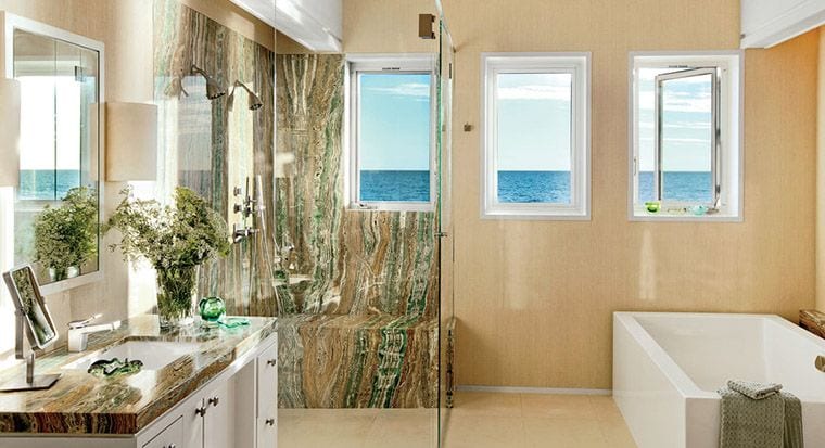 bathroom with blue-and-white tiles and sandy floor
