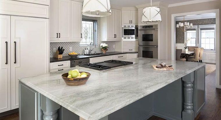 blue and gold marble island and white quartz perimeter countertops